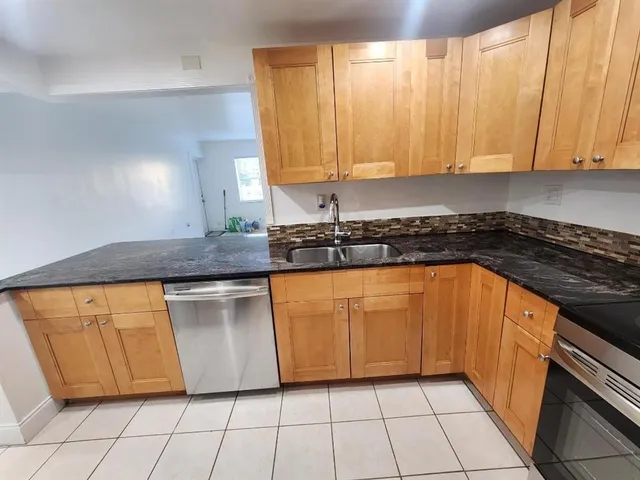a kitchen with stainless steel appliances granite countertop a sink and cabinets