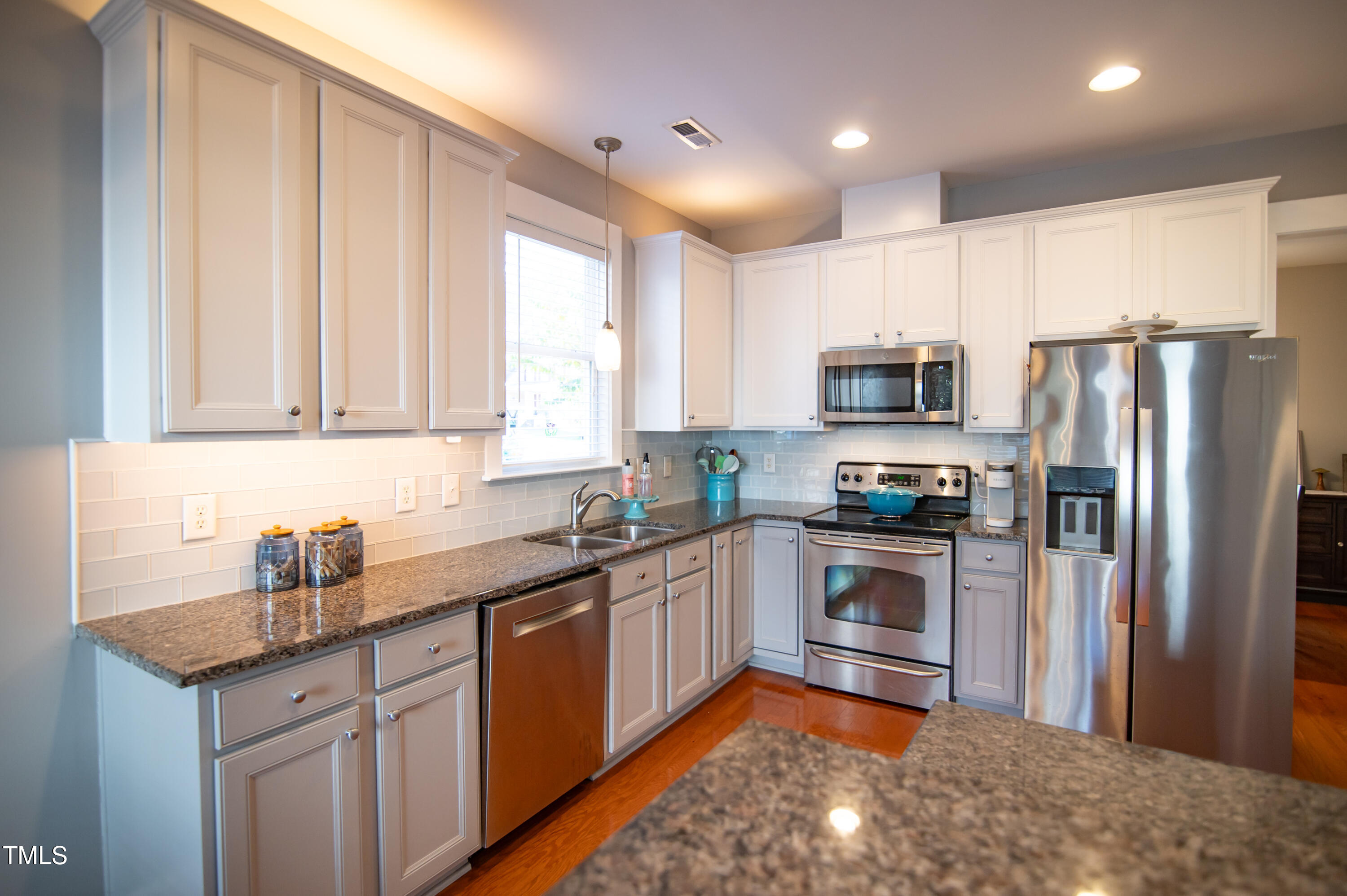 2220 Dunlin Lane Raleigh, NC 27614 - Photo 7 of 38 a kitchen with kitchen island granite countertop a sink stainless steel appliances and cabinets