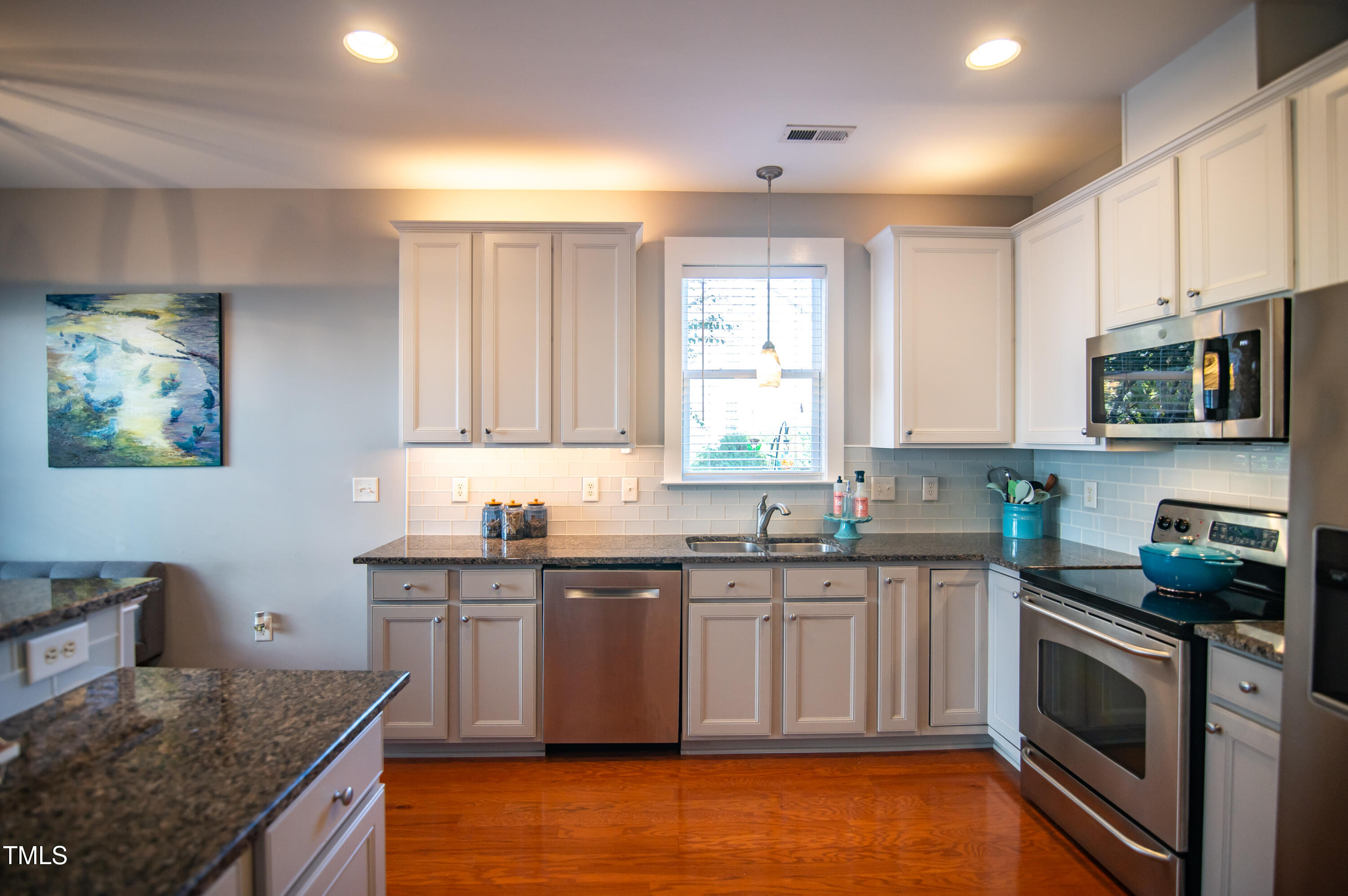 2220 Dunlin Lane Raleigh, NC 27614 - Photo 10 of 38 a kitchen with stainless steel appliances granite countertop a sink a stove top oven a counter space and cabinets