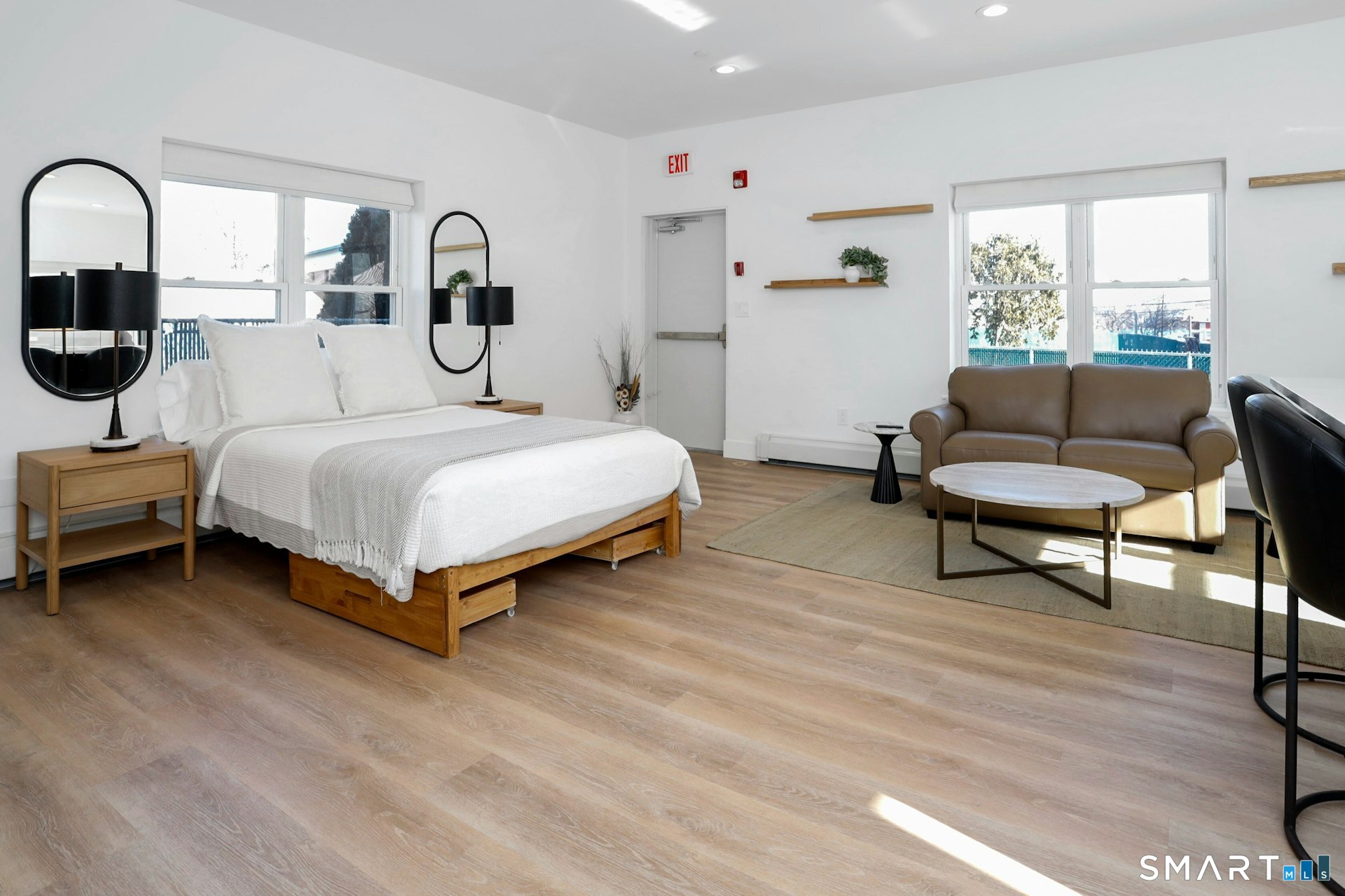 225 Washington Boulevard Stamford, CT 06902 - Photo 11 of 35 a spacious bedroom with a bed a table and chair