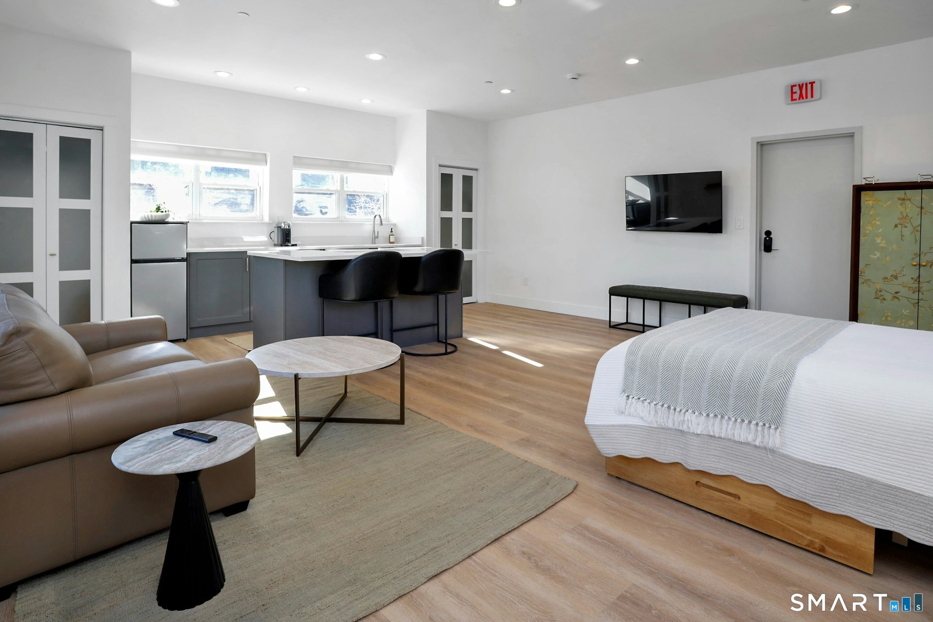 225 Washington Boulevard Stamford, CT 06902 - Photo 12 of 35 a living room with furniture a flat screen tv and a large window