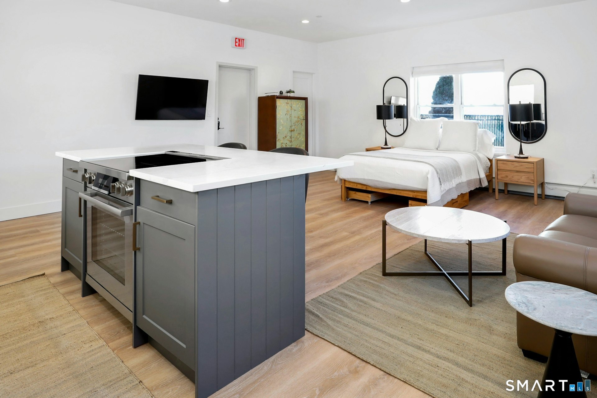 225 Washington Boulevard Stamford, CT 06902 - Photo 14 of 35 a bedroom with furniture and a flat screen tv