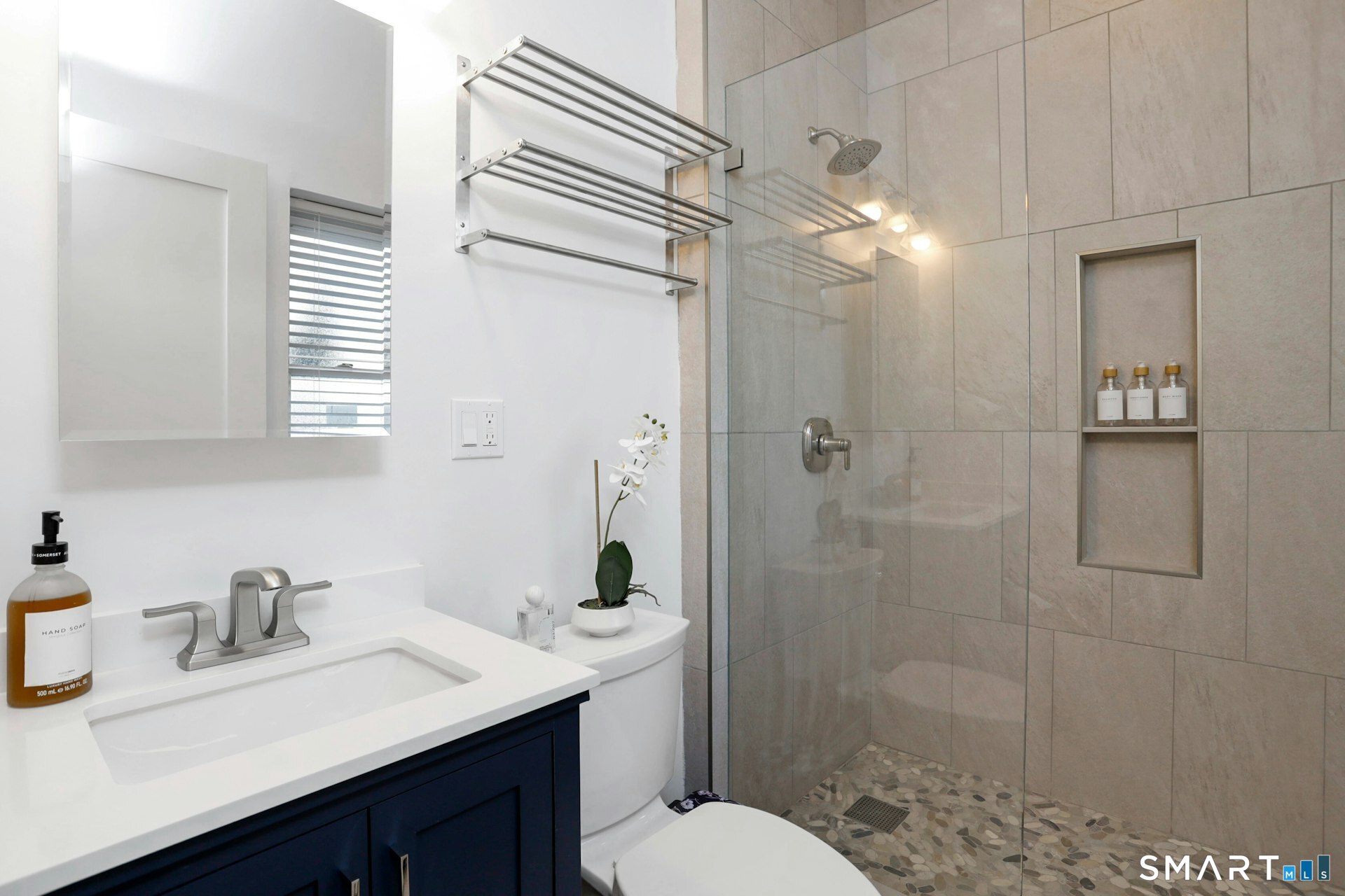225 Washington Boulevard Stamford, CT 06902 - Photo 15 of 35 a bathroom with a sink toilet a mirror and shower