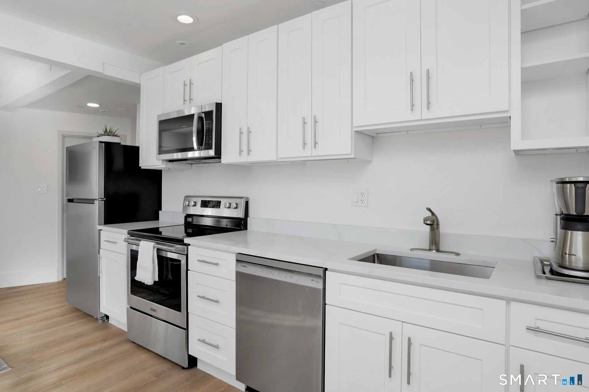 225 Washington Boulevard Stamford, CT 06902 - Photo 18 of 35 a kitchen with white cabinets and stainless steel appliances