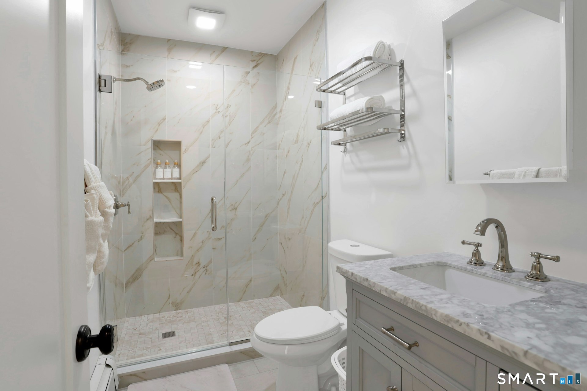 225 Washington Boulevard Stamford, CT 06902 - Photo 24 of 35 a bathroom with a granite countertop sink a toilet and shower