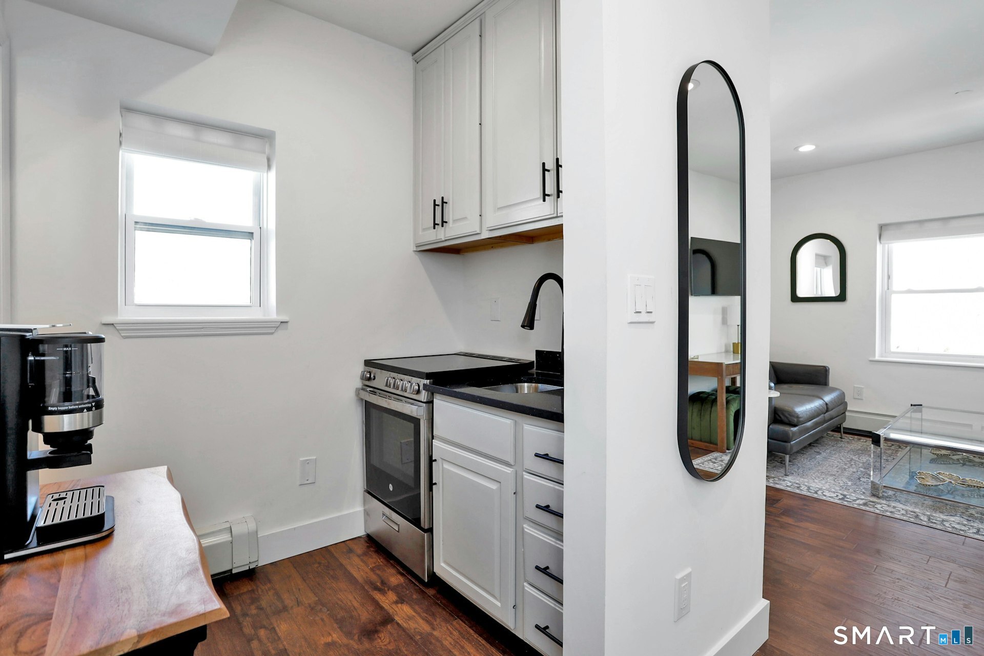 225 Washington Boulevard Stamford, CT 06902 - Photo 28 of 35 a kitchen with stainless steel appliances granite countertop a stove and a wooden floor
