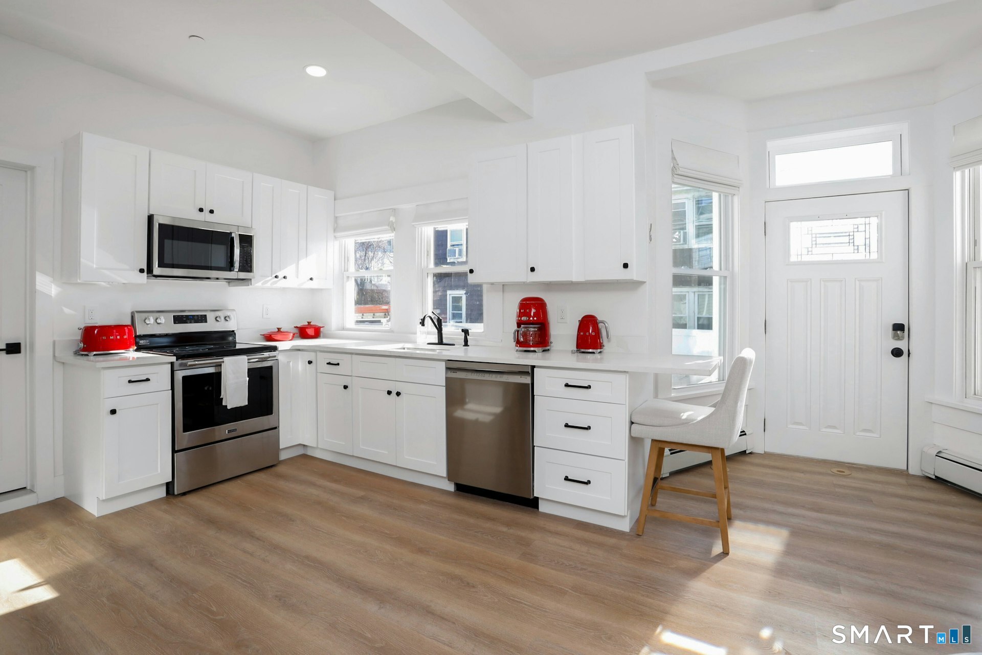 225 Washington Boulevard Stamford, CT 06902 - Photo 3 of 35 a kitchen with white cabinets and stainless steel appliances