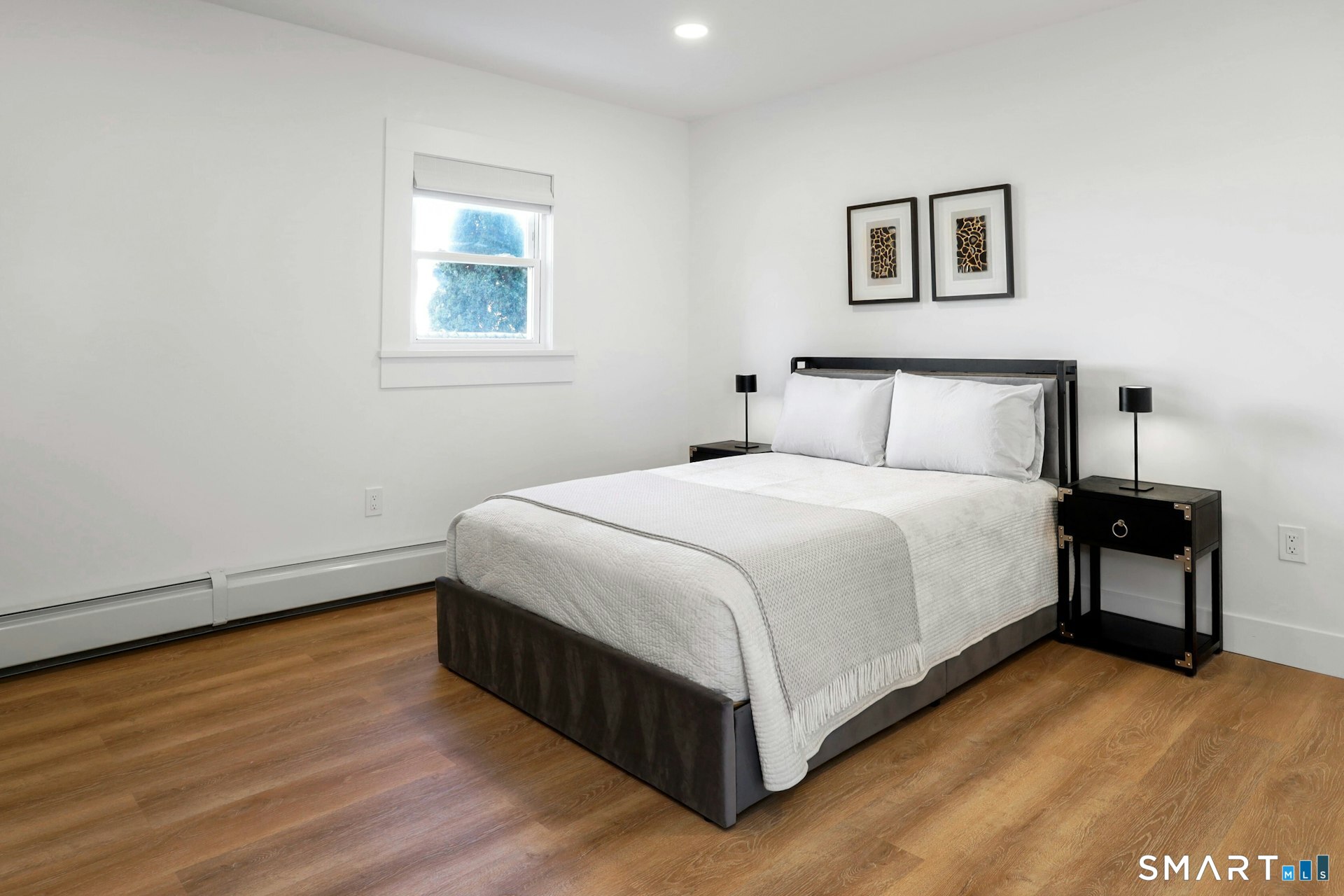 225 Washington Boulevard Stamford, CT 06902 - Photo 9 of 35 a bedroom with a bed and a night stand