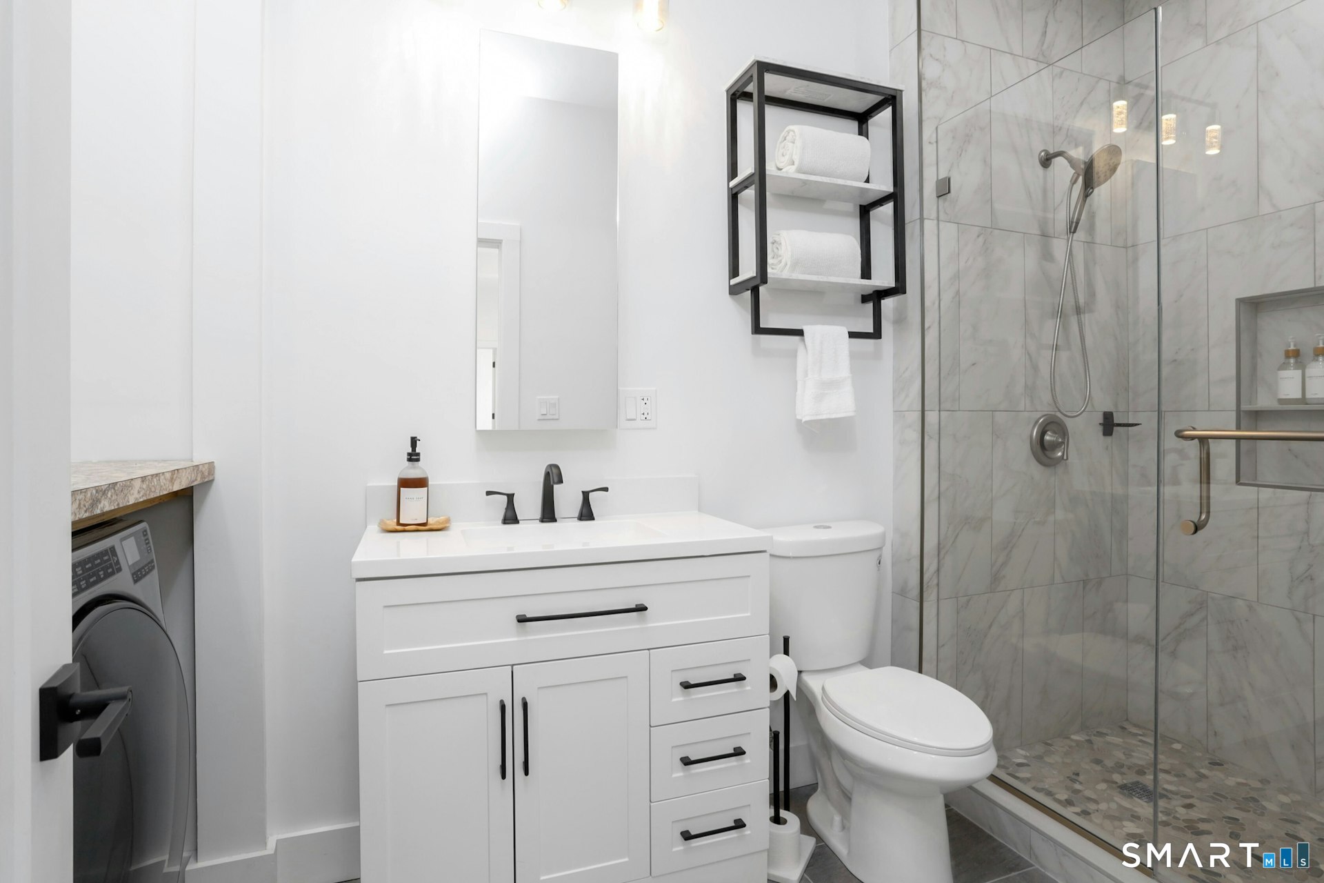 225 Washington Boulevard Stamford, CT 06902 - Photo 10 of 35 a bathroom with a sink toilet and shower