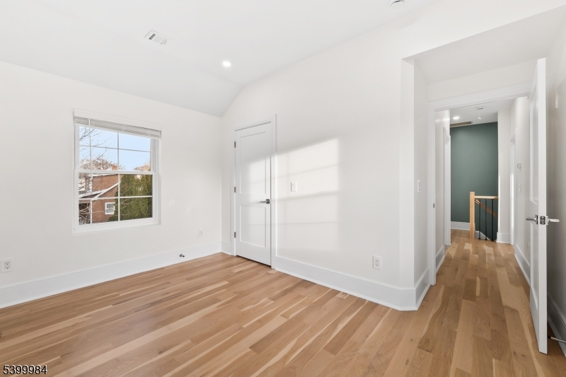 1453 Morris Avenue Union, NJ 07083 - Photo 14 of 48 a view of a big room with wooden floor and windows