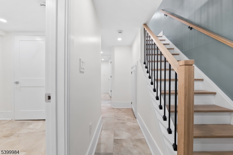 1453 Morris Avenue Union, NJ 07083 - Photo 17 of 48 a view of a hallway with wooden floor and staircase