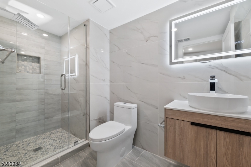 1453 Morris Avenue Union, NJ 07083 - Photo 21 of 48 a bathroom with a sink a toilet and shower