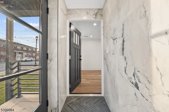 a view of empty room with wooden floor and window