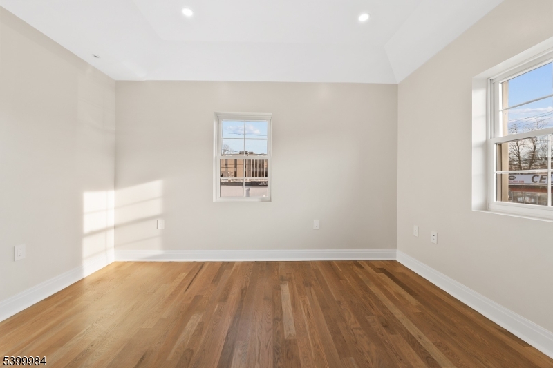 1453 Morris Avenue Union, NJ 07083 - Photo 33 of 48 an empty room with wooden floor and windows