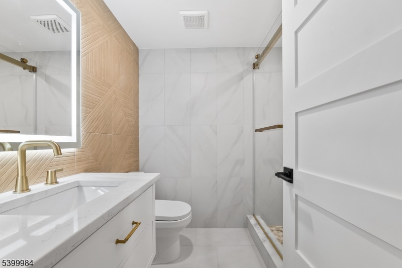 1453 Morris Avenue Union, NJ 07083 - Photo 40 of 48 a bathroom with a sink a toilet and shower