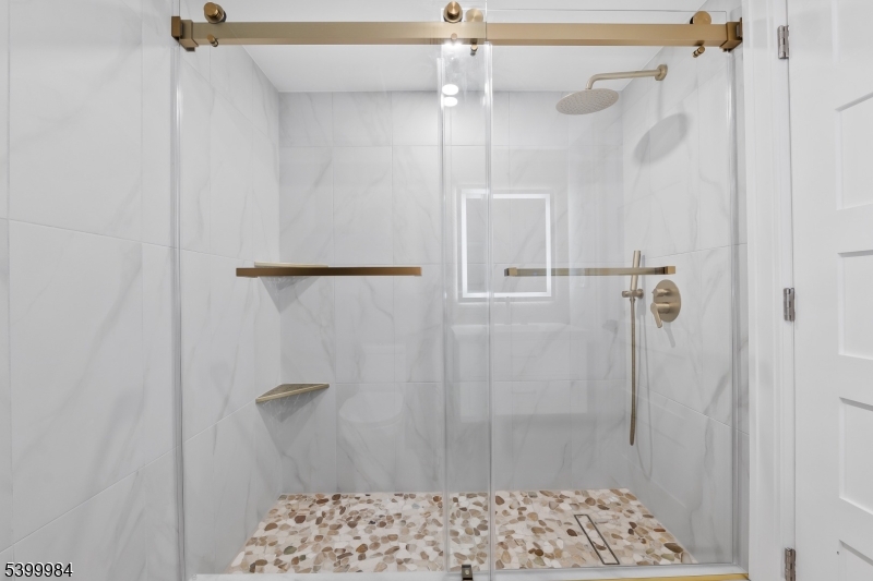 1453 Morris Avenue Union, NJ 07083 - Photo 41 of 48 a bathroom with a shower and a toilet