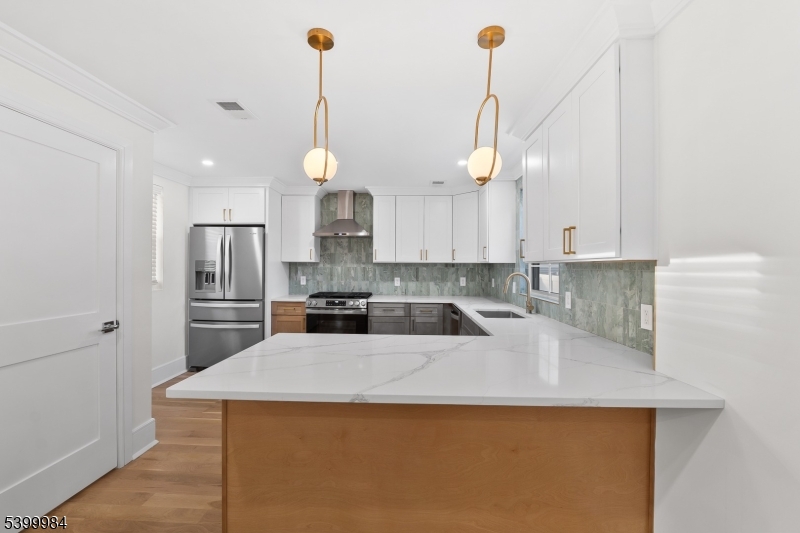 1453 Morris Avenue Union, NJ 07083 - Photo 7 of 48 a kitchen with a sink a counter top space appliances and cabinets