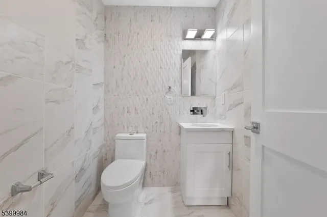 a view of a big room with wooden floor and windows