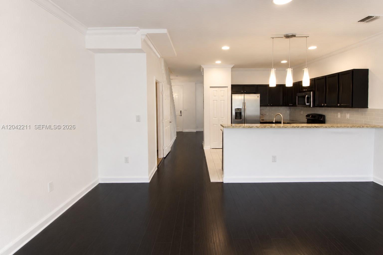 8954 West 35th Way Hialeah, FL 33018 - Photo 9 of 24 a view of a kitchen with a sink and a refrigerator