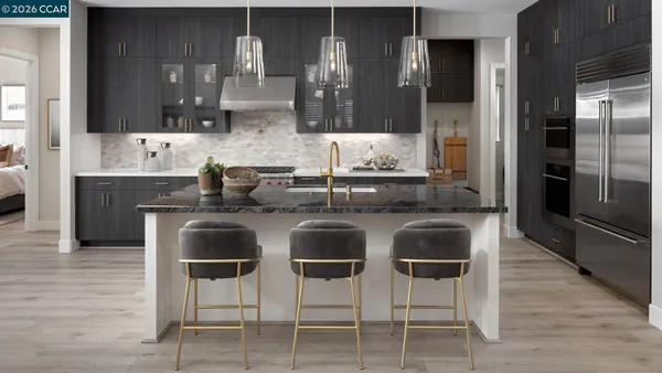 a kitchen with stainless steel appliances granite countertop a sink and cabinets