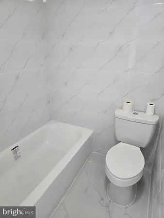 a bathroom with a toilet and bathtub