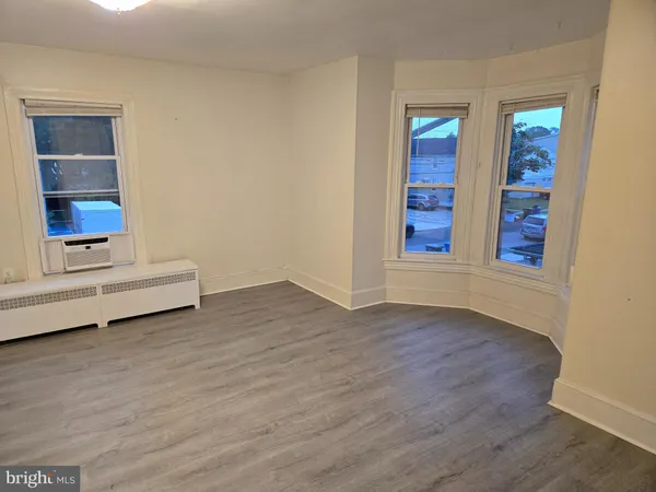 wooden floor and window in an empty room