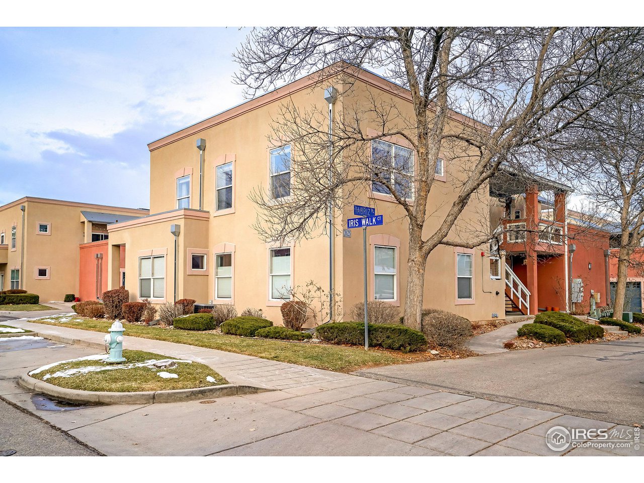 2625 Tabriz Place, Unit 21 Boulder, CO 80304 - Photo 1 of 24 a view of a white house with a road and yard