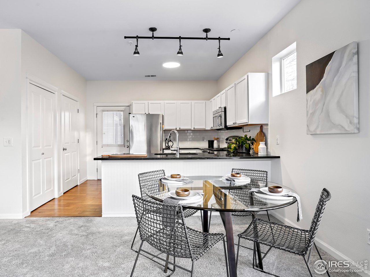 2625 Tabriz Place, Unit 21 Boulder, CO 80304 - Photo 10 of 24 a kitchen with stainless steel appliances kitchen island granite countertop a sink and cabinets
