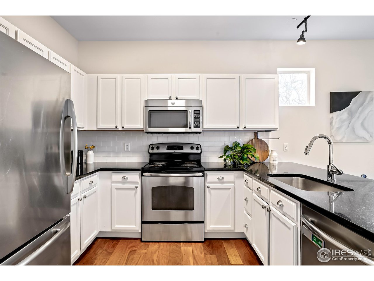 2625 Tabriz Place, Unit 21 Boulder, CO 80304 - Photo 6 of 24 a kitchen with stainless steel appliances a stove a sink cabinets and a refrigerator
