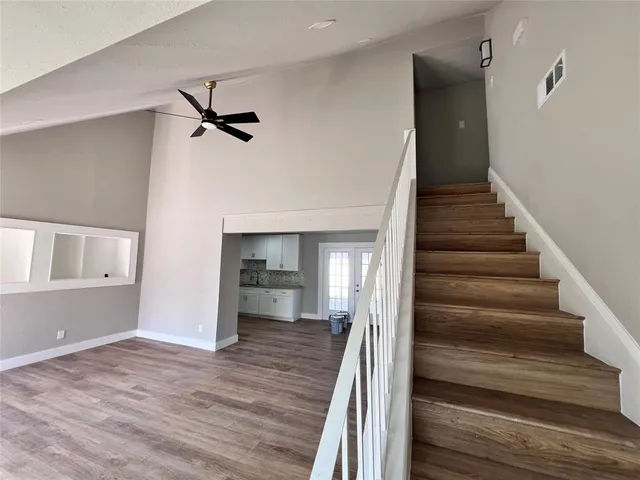 a view of a hallway view with wooden floor and staircase