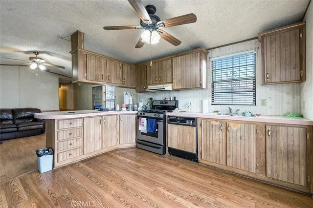 a kitchen with cabinets wooden floor and a sink