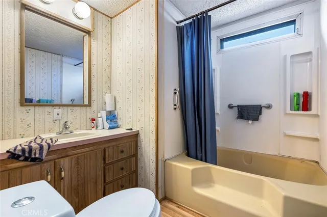 a bathroom with a sink a toilet and bathtub