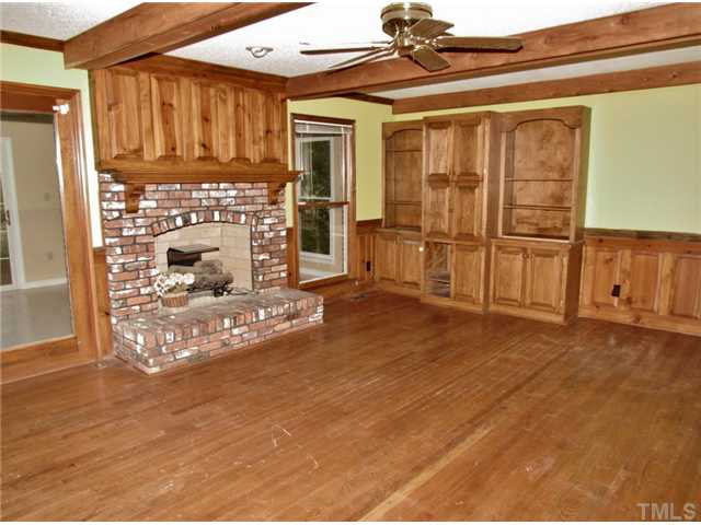 5000 Holly Ridge Farm Road Raleigh, NC 27616 - Photo 8 of 25 Large Family Room with Wood Beams in Ceiling, Built In Shelves & Decorative Wood Paneling and Cozy Brick Fire Place with Custom Mantel! Home #1 Den/Family/Great Room