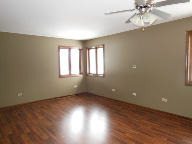 5811 Wild Plum Road Crystal Lake, IL 60014 - Photo 7 of 8 an empty room with wooden floor and windows
