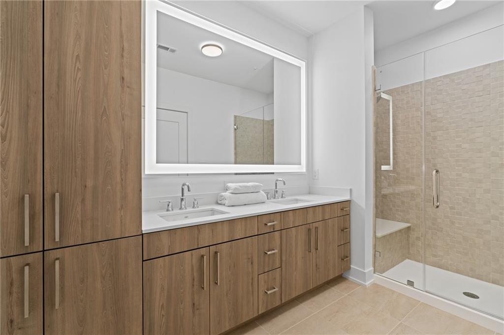 775 Juniper Street Northeast, Unit 227 Atlanta, GA 30308 - Photo 12 of 42 a bathroom with a double vanity sink and mirror
