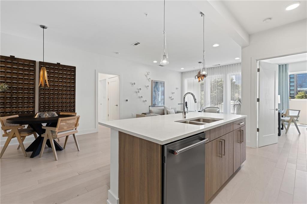 775 Juniper Street Northeast, Unit 227 Atlanta, GA 30308 - Photo 4 of 42 a kitchen with a sink a table and chairs