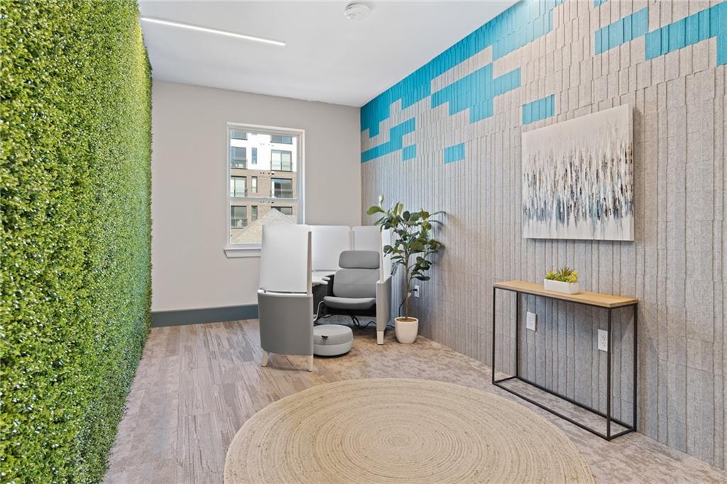 775 Juniper Street Northeast, Unit 227 Atlanta, GA 30308 - Photo 41 of 42 a bedroom with a bed and a table