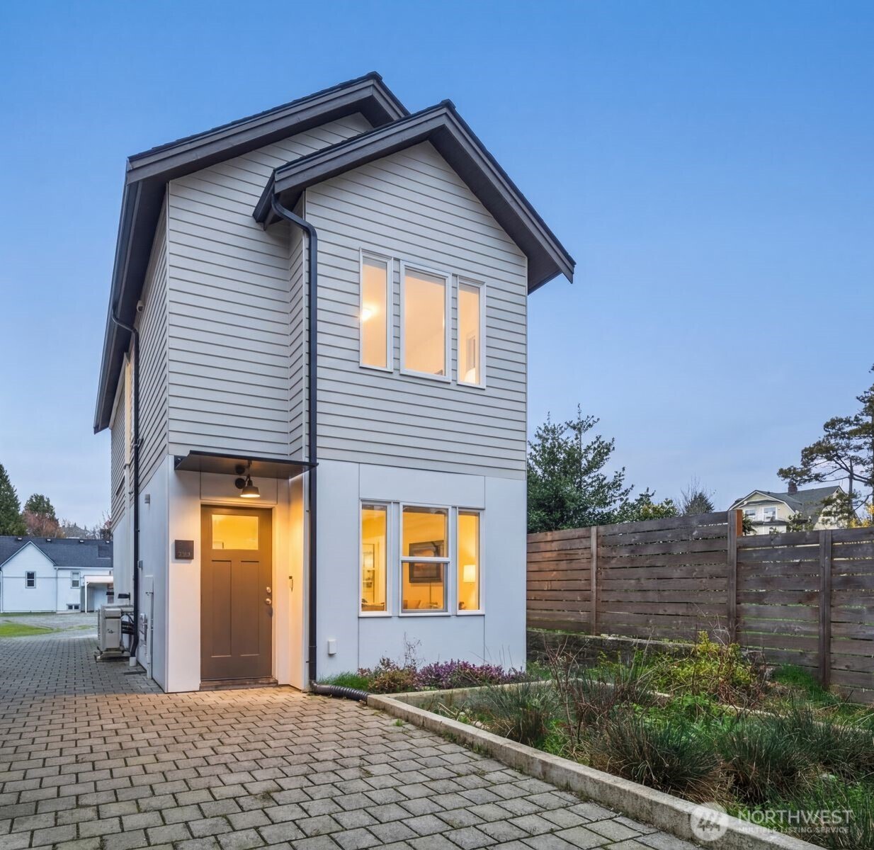 a view of a house with a small yard and plants