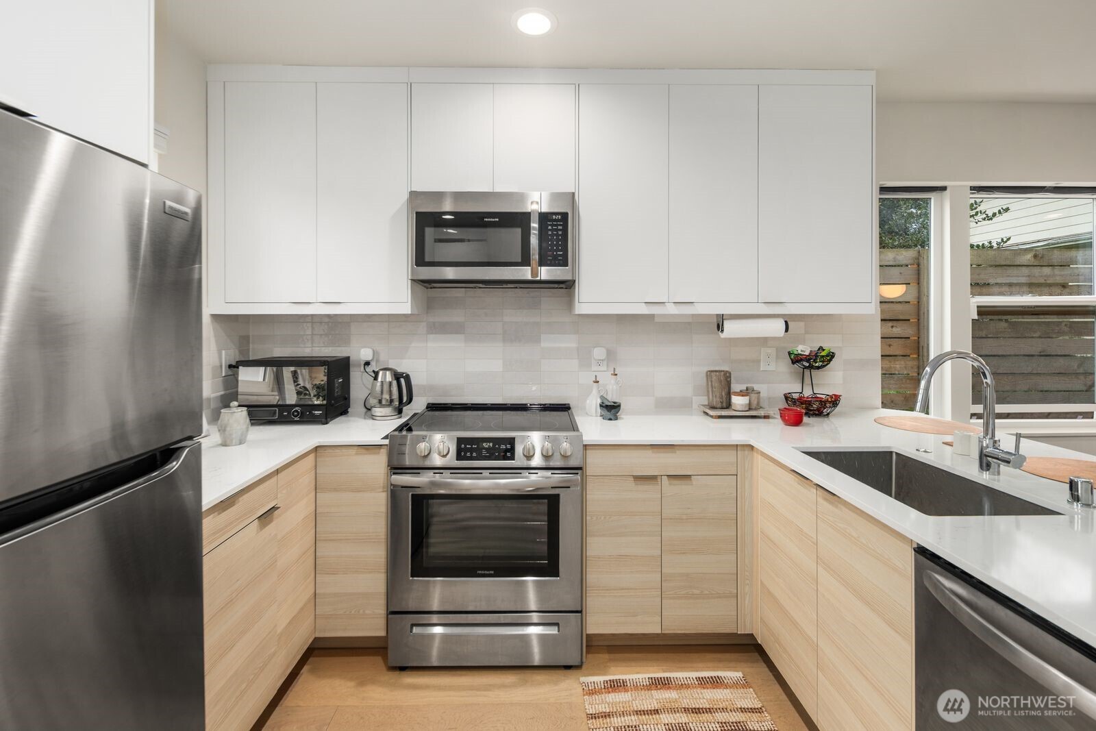 2211 17th Avenue South Seattle, WA 98144 - Photo 11 of 25 a kitchen with white cabinets and white appliances