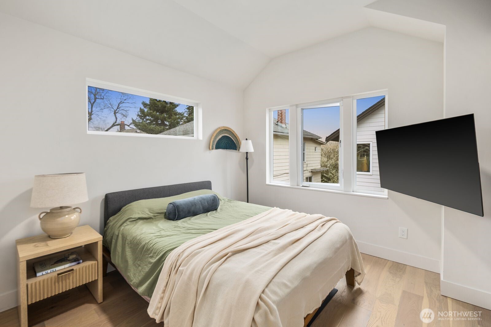 2211 17th Avenue South Seattle, WA 98144 - Photo 15 of 25 a bedroom with a bed and a flat screen tv