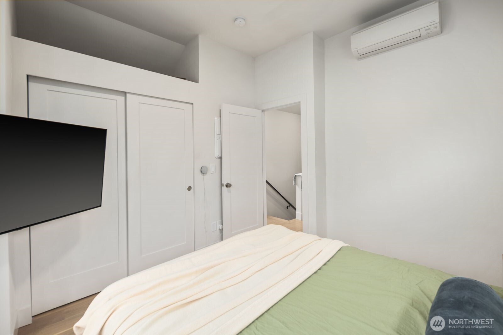 2211 17th Avenue South Seattle, WA 98144 - Photo 17 of 25 a bedroom with a bed and a flat screen tv