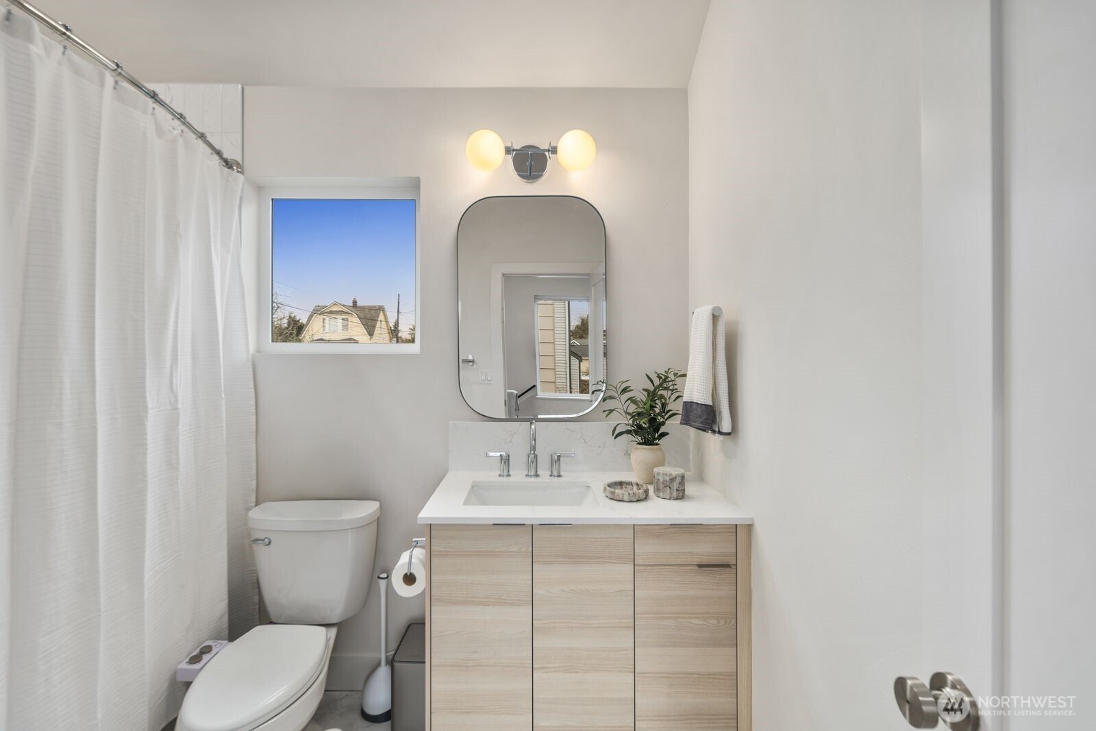 2211 17th Avenue South Seattle, WA 98144 - Photo 19 of 25 a bathroom with a toilet sink and mirror