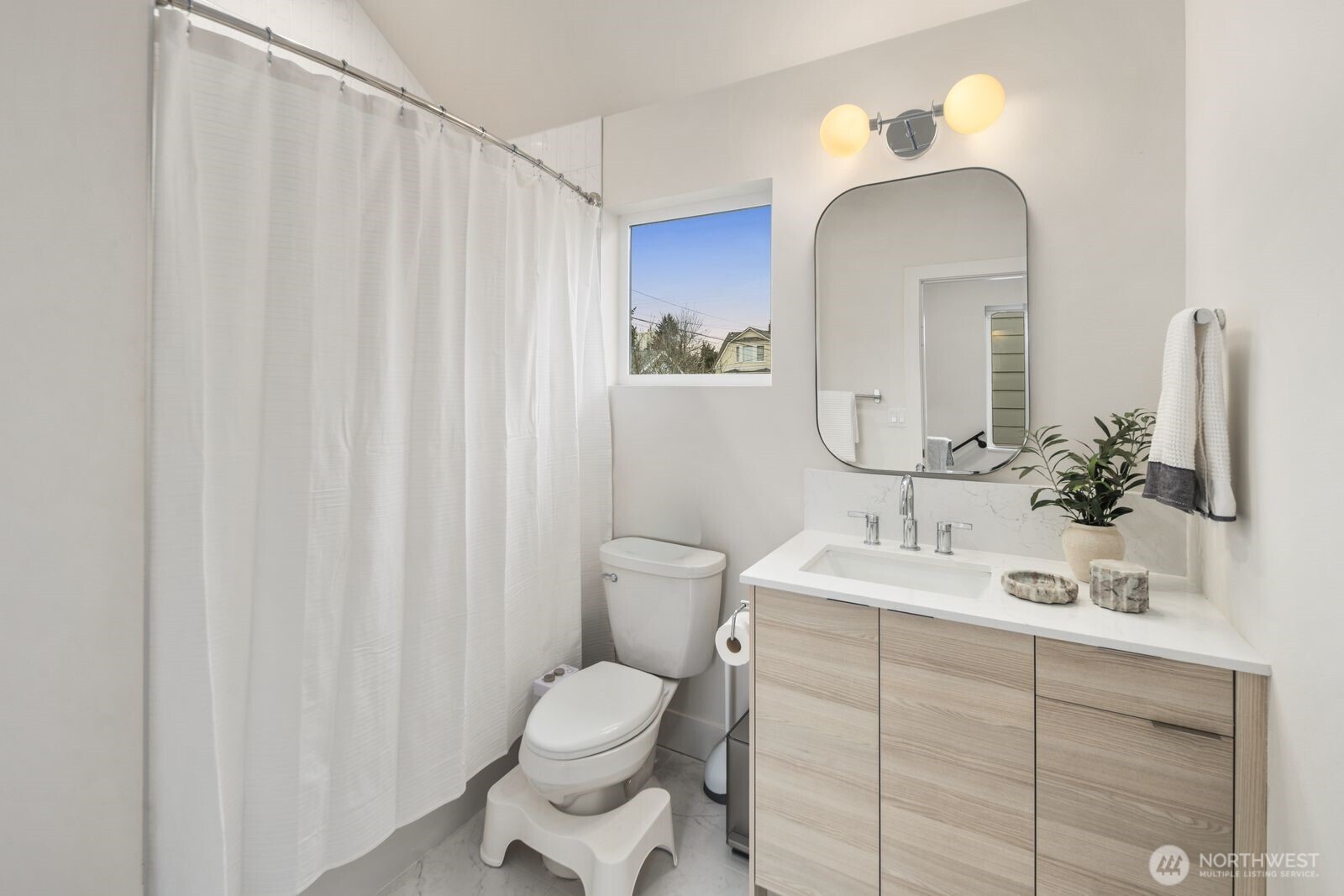 2211 17th Avenue South Seattle, WA 98144 - Photo 20 of 25 a bathroom with a toilet sink and mirror