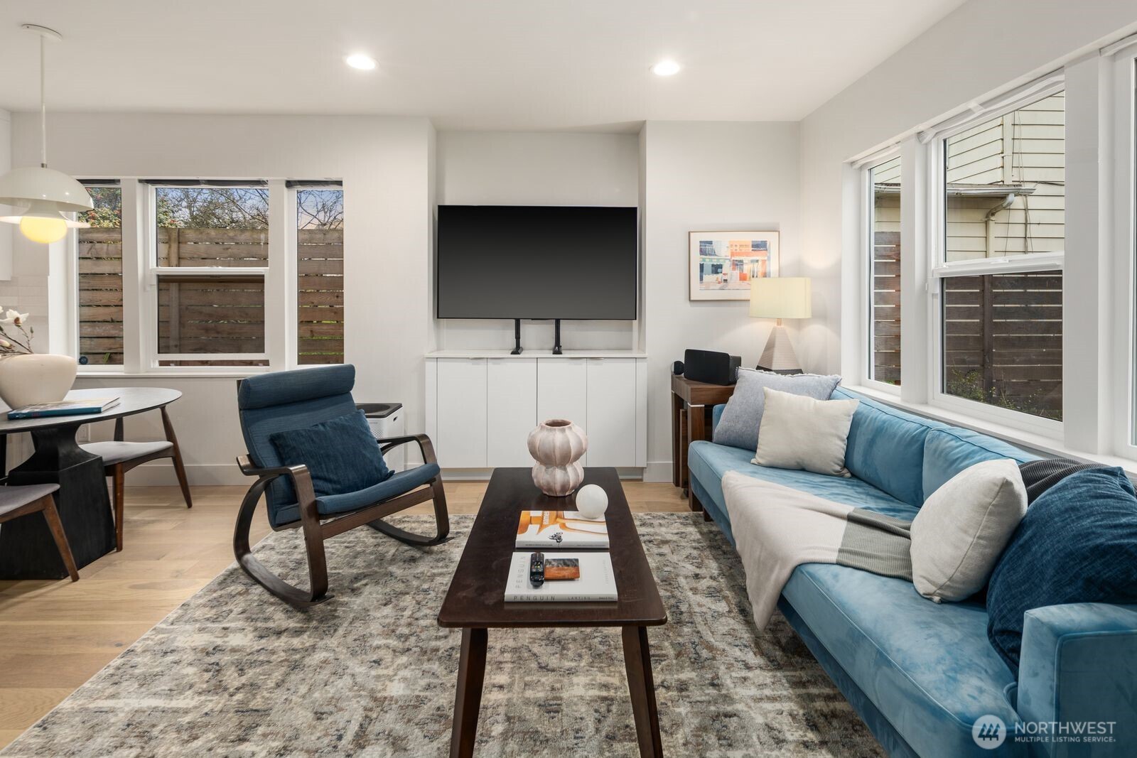 2211 17th Avenue South Seattle, WA 98144 - Photo 3 of 25 a living room with furniture a flat screen tv and a large window