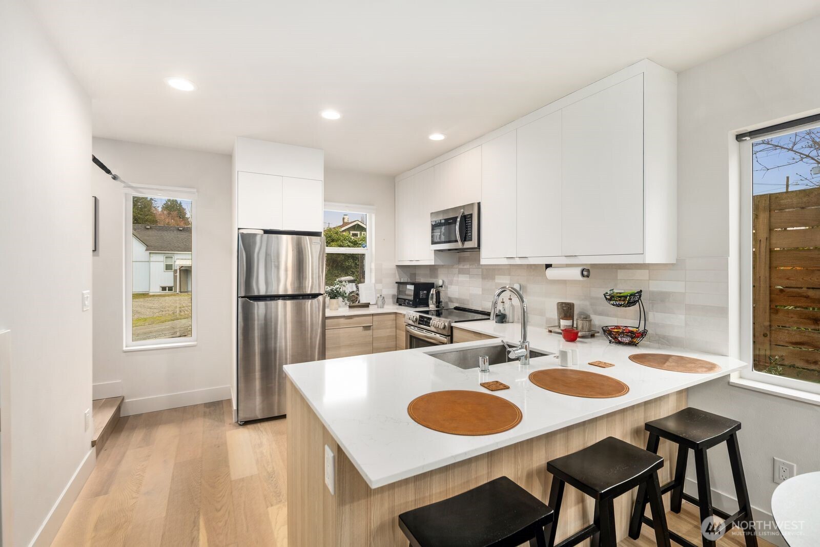 2211 17th Avenue South Seattle, WA 98144 - Photo 9 of 25 a kitchen with sink refrigerator dining table and chairs