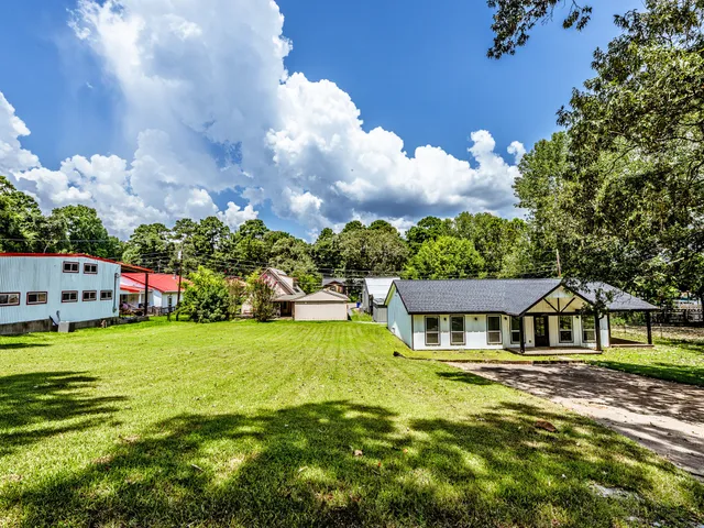 a front view of house with yard and green space