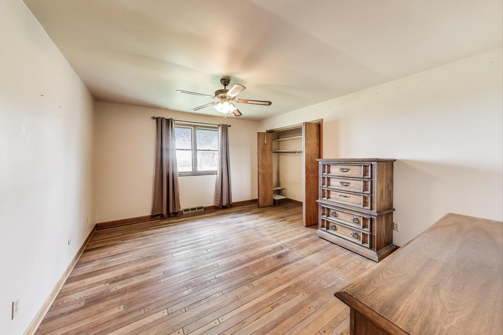 7008 West Kennedy Road Peotone, IL 60468 - Photo 19 of 41 wooden floor in an empty room with a window