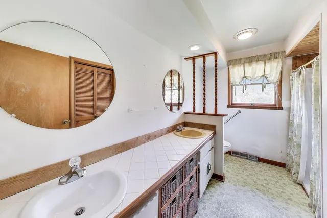 a bathroom with a sink mirror and a bathtub