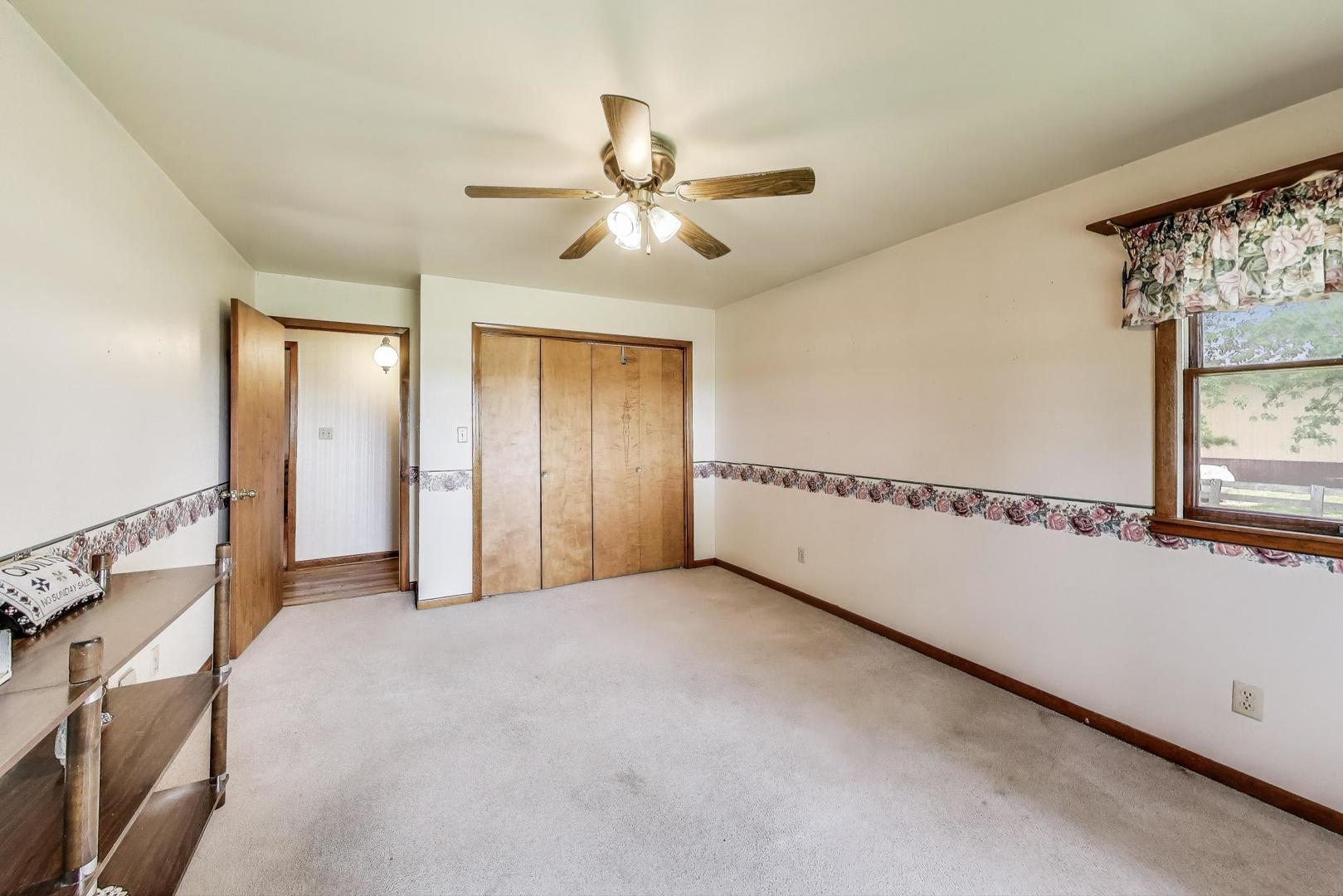 7008 West Kennedy Road Peotone, IL 60468 - Photo 23 of 41 a view of a livingroom with a ceiling fan and window