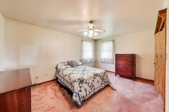 a bedroom with a bed and dresser